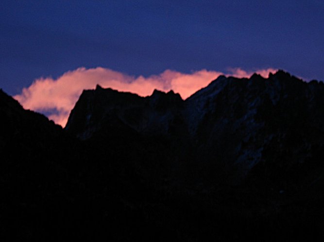 Before sunrise, a bright pink cloud framed Cardinal's summit and central notch.